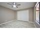 Spacious bedroom with ceiling fan, sliding closet doors, and wood-look floors at 520 S Sand Verbena Way, Mesa, AZ 85208