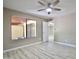 Bedroom with ceiling fan, wood-look floors, and view to backyard at 520 S Sand Verbena Way, Mesa, AZ 85208