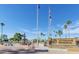 Beautifully maintained community grounds featuring a monument, fountain, and mature trees under clear blue skies at 520 S Sand Verbena Way, Mesa, AZ 85208