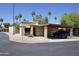 Inviting home with a carport and low maintenance desert landscaping, nestled in a charming neighborhood with mature palm trees at 520 S Sand Verbena Way, Mesa, AZ 85208