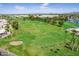Manicured golf course featuring sand traps and putting greens, surrounded by lush trees at 520 S Sand Verbena Way, Mesa, AZ 85208