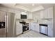 Modern kitchen with stainless steel appliances, quartz countertops, white cabinets, and a stainless steel dishwasher at 520 S Sand Verbena Way, Mesa, AZ 85208