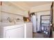 Functional laundry room with appliances, storage shelves, and water heater at 520 S Sand Verbena Way, Mesa, AZ 85208