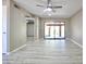Bright living room featuring sliding glass doors to the patio, and wood-look floors, with white trim and a ceiling fan at 520 S Sand Verbena Way, Mesa, AZ 85208