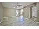 Bright living room with wood-look floors, neutral walls, and views of the front door and a hallway with a full bathroom at 520 S Sand Verbena Way, Mesa, AZ 85208