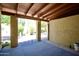 Covered outdoor patio with blue flooring and desert landscaping at 520 S Sand Verbena Way, Mesa, AZ 85208