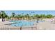 Community swimming pool surrounded by lounge chairs and shady pergolas, promoting a relaxing lifestyle at 520 S Sand Verbena Way, Mesa, AZ 85208