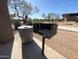 Barbeque grill and trashcan area next to a sidewalk in the park at 5650 E Ocupado Dr, Cave Creek, AZ 85331