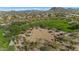 Aerial view of basketball court surrounded by desert landscaping, grass, and homes at 5650 E Ocupado Dr, Cave Creek, AZ 85331