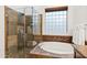 Beautiful bathroom with a walk-in shower, soaking tub and stone details at 5650 E Ocupado Dr, Cave Creek, AZ 85331