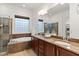 Luxurious bathroom with a soaking tub, walk-in shower, double vanity, and elegant finishes at 5650 E Ocupado Dr, Cave Creek, AZ 85331