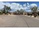 Gated entrance to the Lone Mountain community with desert landscaping and paved road at 5650 E Ocupado Dr, Cave Creek, AZ 85331