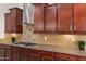 Gourmet kitchen with stone countertops, stainless steel appliances, custom cabinets, and tiled backsplash at 5650 E Ocupado Dr, Cave Creek, AZ 85331
