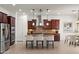 Modern kitchen with stainless steel appliances, dark wood cabinets, and a center island with seating at 5650 E Ocupado Dr, Cave Creek, AZ 85331