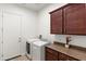 Bright laundry room with washer, dryer, and granite countertop on cabinets at 5650 E Ocupado Dr, Cave Creek, AZ 85331