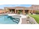 Beautiful backyard featuring a pool, covered patio, and lush landscaping at 5650 E Ocupado Dr, Cave Creek, AZ 85331