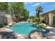 Backyard pool features rock features, landscaping, and a desert backdrop to add to the charm at 5758 E Fox St, Mesa, AZ 85205