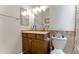 Bathroom with a modern vanity, decorative tile, and a toilet near the sink and cabinets at 5758 E Fox St, Mesa, AZ 85205