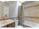 Well-maintained bathroom featuring a tiled shower and tub combination with a white sink vanity at 5758 E Fox St, Mesa, AZ 85205