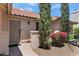 Warm welcome with a decorative front door, desert landscaping, and a well-lit porch at 5758 E Fox St, Mesa, AZ 85205