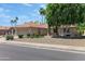 Inviting single-story home featuring mature trees, desert landscaping, and a tile roof at 5758 E Fox St, Mesa, AZ 85205