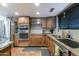 Updated kitchen with stainless steel appliances, granite countertops, and modern cabinetry at 5758 E Fox St, Mesa, AZ 85205