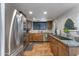 Modern kitchen featuring stainless steel appliances, granite countertops, and ample cabinet space at 5758 E Fox St, Mesa, AZ 85205