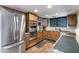 Stylish kitchen with stainless steel appliances, custom cabinetry, granite countertops, and tiled floors at 5758 E Fox St, Mesa, AZ 85205