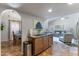 Open kitchen featuring a granite countertop island, seamlessly flowing into the living and dining areas at 5758 E Fox St, Mesa, AZ 85205