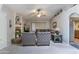 Cozy living room features plush seating, a ceiling fan, and a decorative fireplace at 5758 E Fox St, Mesa, AZ 85205