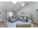 Bright living room with vaulted ceilings, skylight, comfortable seating, and sliding glass door to outdoor space at 5758 E Fox St, Mesa, AZ 85205