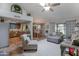 Bright living room with vaulted ceiling, skylight, and an open floor plan to the kitchen and dining areas at 5758 E Fox St, Mesa, AZ 85205