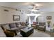 Spacious living room with comfortable seating, a ceiling fan, and arched entryways at 5758 E Fox St, Mesa, AZ 85205