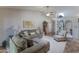 Inviting living room with comfortable seating, a ceiling fan, and a calming, neutral color palette at 5758 E Fox St, Mesa, AZ 85205