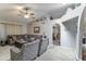 Bright and airy living room with cozy seating, a ceiling fan, and neutral decor at 5758 E Fox St, Mesa, AZ 85205