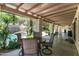 Covered patio with outdoor seating, a view of the pool and landscaped backyard with mature landscaping at 5758 E Fox St, Mesa, AZ 85205