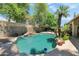 The backyard features a beautiful pool, lush tropical landscaping, and rock waterfall features at 5758 E Fox St, Mesa, AZ 85205