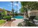 A backyard swimming pool features tropical landscaping, desert views, and a lounge chair for relaxing at 5758 E Fox St, Mesa, AZ 85205