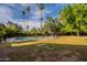 A scenic backyard featuring a private pool area and a lush lawn with mature trees at 6525 N 3Rd St, Phoenix, AZ 85012