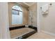 Bathroom featuring decorative tile, soaking tub, tile surround, and shower at 6525 N 3Rd St, Phoenix, AZ 85012