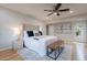 Bright bedroom featuring neutral tones, ceiling fan, hardwood floors, and doors to the outside at 6525 N 3Rd St, Phoenix, AZ 85012