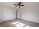 A bright bedroom features a closet with sliding doors and a ceiling fan at 6525 N 3Rd St, Phoenix, AZ 85012