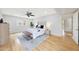 Bright bedroom featuring hardwood floors, ceiling fan, and a tufted headboard at 6525 N 3Rd St, Phoenix, AZ 85012