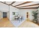 Bright dining room boasts hardwood floors, wooden beams, and neutral tones at 6525 N 3Rd St, Phoenix, AZ 85012