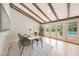 Open dining area with wooden beams, view of the pool through glass doors at 6525 N 3Rd St, Phoenix, AZ 85012