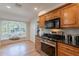 Charming kitchen with stainless steel appliances, and a window seat with backyard views at 6525 N 3Rd St, Phoenix, AZ 85012