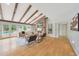 Bright living room featuring wood beam ceilings, a brick fireplace, and access to outdoor pool at 6525 N 3Rd St, Phoenix, AZ 85012