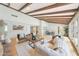 Spacious living room with exposed wood beams, hardwood floors, and an open-concept design at 6525 N 3Rd St, Phoenix, AZ 85012