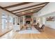 Cozy living room with a striking brick fireplace, wood beam ceilings, and modern decor at 6525 N 3Rd St, Phoenix, AZ 85012