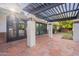 A covered patio with a wooden pergola, tile floor, and stylish columns at 6525 N 3Rd St, Phoenix, AZ 85012